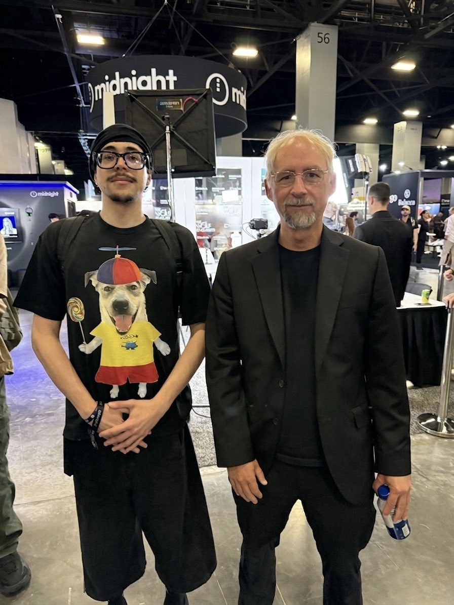 Gleece wearing the $ROSCOE shirt next to Adam Back